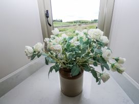 A flower pot with white flowers on a surface at Crane Field Laithe in Otterburn, North Yorkshire
