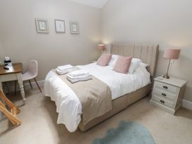 A bedroom with a bed and desk at Crane Field Laithe in Otterburn, North Yorkshire