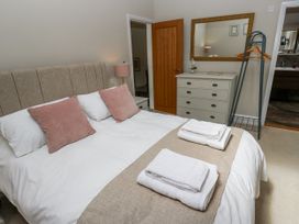 A bedroom with a bed and dresser at Crane Field Laithe in Otterburn, North Yorkshire