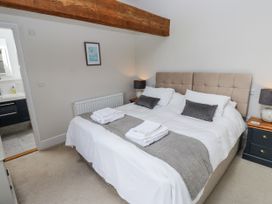 A bedroom with a bed and bedside tables at Crane Field Laithe in Otterburn, North Yorkshire