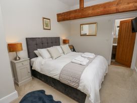 A bedroom with a bed and lamps at Crane Field Laithe in Otterburn, North Yorkshire