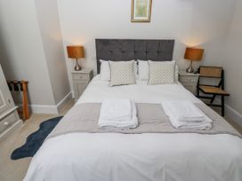 A bedroom with a double bed and bedside tables at Crane Field Laithe Otterburn, North Yorkshire
