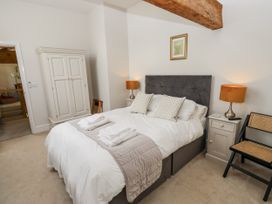 A bedroom with a bed and wardrobe at Crane Field Laithe Otterburn North Yorkshire
