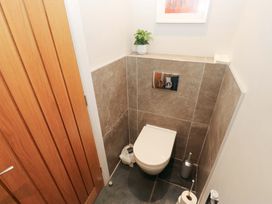 A bathroom with a toilet and a plant at Crane Field Laithe in Otterburn, North Yorkshire
