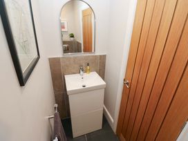 A bathroom with a sink and mirror at Crane Field Laithe Otterburn North Yorkshire
