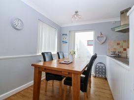 A dining room with a table and chairs at Beach House (Ty Traeth) Deganwy
