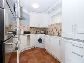 A kitchen with appliances and counter space at Beach House (Ty Traeth) in Deganwy