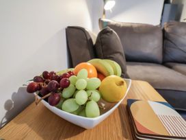 A fruit bowl with assorted fruits on a coffee table at All Aboard in Whitby