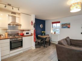A kitchen with dining area and sofa at All Aboard in Whitby
