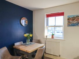 A dining room with a table and chairs at All Aboard in Whitby