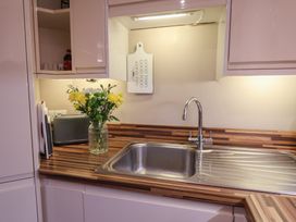 A kitchen with a sink and flower vase at All Aboard in Whitby