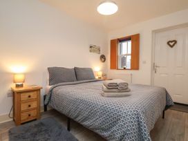 A bedroom with a double bed and bedside table at All Aboard in Whitby