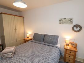 A bedroom with a bed and wardrobe at All Aboard in Whitby