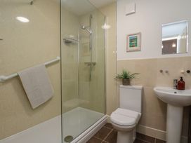 A bathroom with a shower, toilet, and sink at All Aboard in Whitby