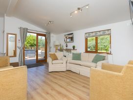 A living room with a sofa and armchairs at Costentyn, Tor Down Quarry in St Breward