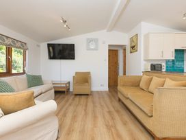 A living room with a television and sofa at Costentyn, Tor Down Quarry St Breward