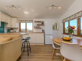 A kitchen with a table and chairs at Costentyn, Tor Down Quarry St Breward