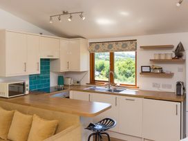 A kitchen with wooden countertop and window at Costentyn, Tor Down Quarry in St Breward