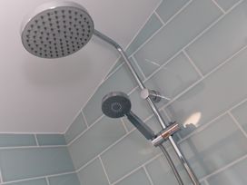 A shower with a fixed and handheld showerhead at Costentyn, Tor Down Quarry St Breward