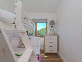 A bedroom with a bunk bed and a chest of drawers at Costentyn, Tor Down Quarry St Breward