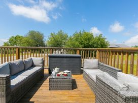 An outdoor seating area with sofas and a coffee table at Costentyn, Tor Down Quarry St Breward