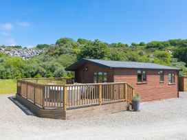 A log cabin with a deck at Costentyn, Tor Down Quarry St Breward
