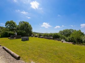 A garden with grass and outdoor seating at Costentyn, Tor Down Quarry St Breward