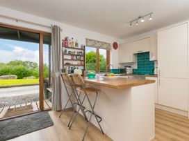 A kitchen with countertop and bar stools at Tressa, Tor Down Quarry in St Breward