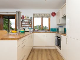 A kitchen with a sink, counter, and shelves at Tressa, Tor Down Quarry St Breward
