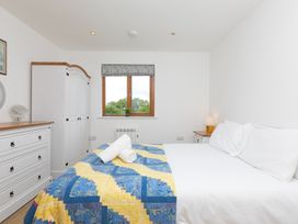 A bedroom with a double bed and wardrobe at Tressa, Tor Down Quarry in St Breward