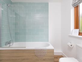A bathroom with a bathtub and shower at Tressa, Tor Down Quarry in St Breward