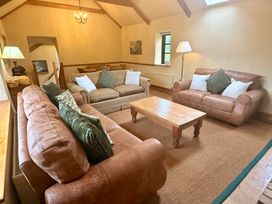 A living room with sofas and a coffee table at Meadow Cottage in Golant, near Fowey