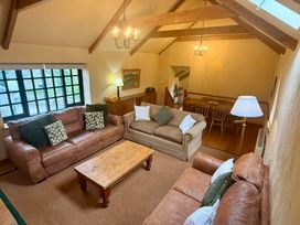 A living room with sofas and dining area at Meadow Cottage in Golant, near Fowey