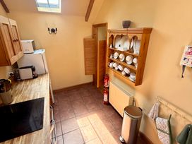 A kitchen with cabinets and appliances at Meadow Cottage Golant near Fowey