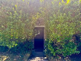 A door framed by plants at Meadow Cottage in Golant, near Fowey