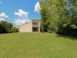 A house with a balcony and a lawn at Frater House in Denton near Harleston