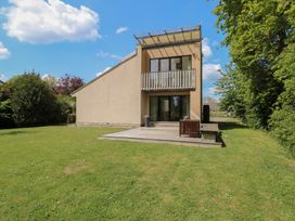 An exterior view of a house with a balcony and deck at Frater House in Denton near Harleston