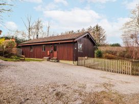 A wooden house with a gravel front yard at 26 Dukes Meadow in Greystoke near Penrith