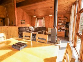 A living room with a sofa and dining area at 26 Dukes Meadow Greystoke near Penrith