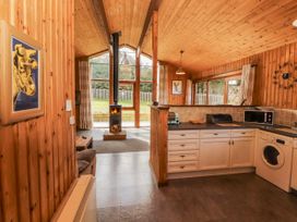 A kitchen with a stove and washing machine at 26 Dukes Meadow Greystoke near Penrith