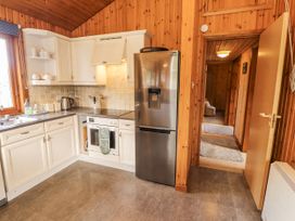 A kitchen with appliances and cabinets at 26 Dukes Meadow Greystoke near Penrith
