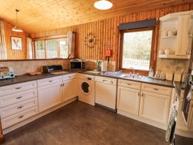 A kitchen with cabinets and appliances at 26 Dukes Meadow Greystoke near Penrith