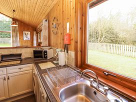 A kitchen with a sink and microwave at 26 Dukes Meadow Greystoke near Penrith