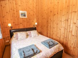 A bedroom with a bed and towels at 26 Dukes Meadow Greystoke near Penrith
