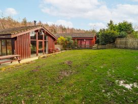 A garden with houses and grassy area at 26 Dukes Meadow in Greystoke near Penrith
