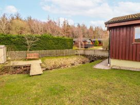 A garden area with a wooden bench and pathway at 26 Dukes Meadow Greystoke near Penrith