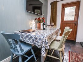 A dining room with table and chairs at The Coach House in Prestatyn