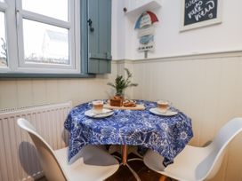 A dining room with a table set for two at The Coach House in Prestatyn