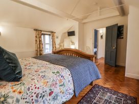 A bedroom with a bed and dressing table at The Coach House in Prestatyn