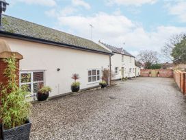 An outdoor area with a building and gravel driveway at The Coach House in Prestatyn